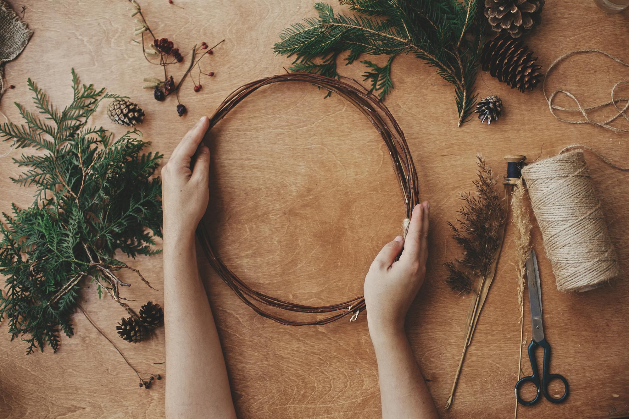Artist hands stitching a hoop in studio