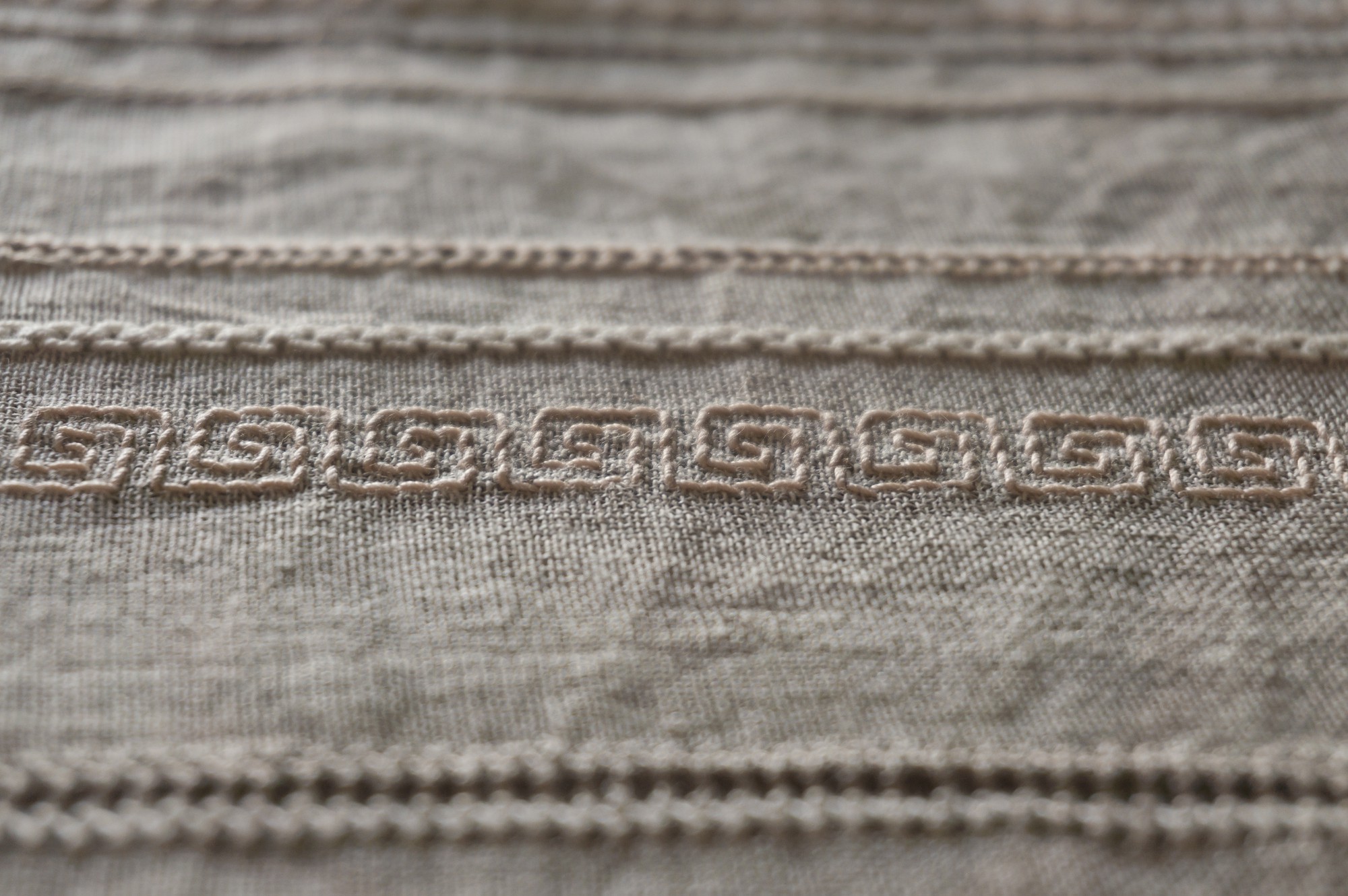 Close-up of modern embroidered detail on linen